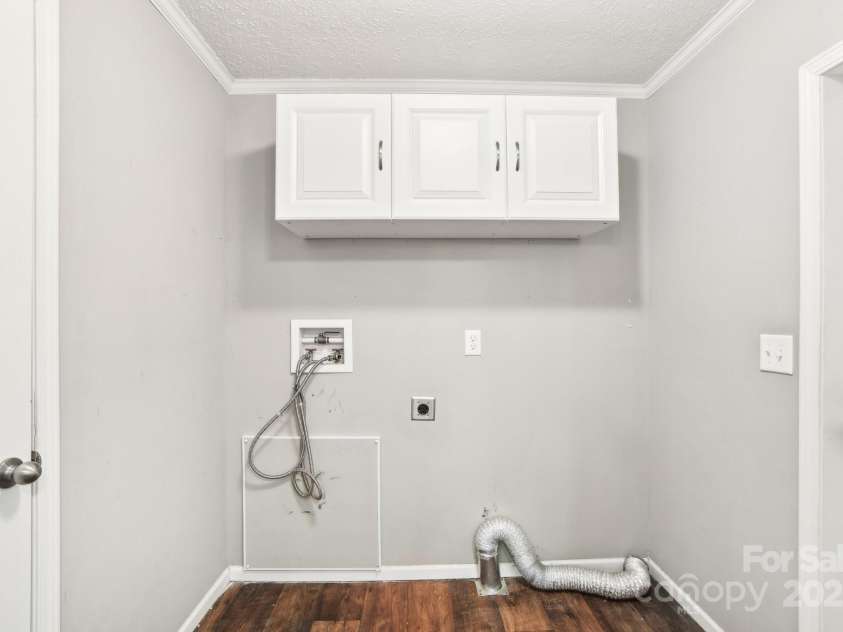 296 Sentelle Lane, Hendersonville, NC 28739.  MLS# CAR4226674, YatesRealty ID 5255. Laundry area complete with cabinets just off the kitchen