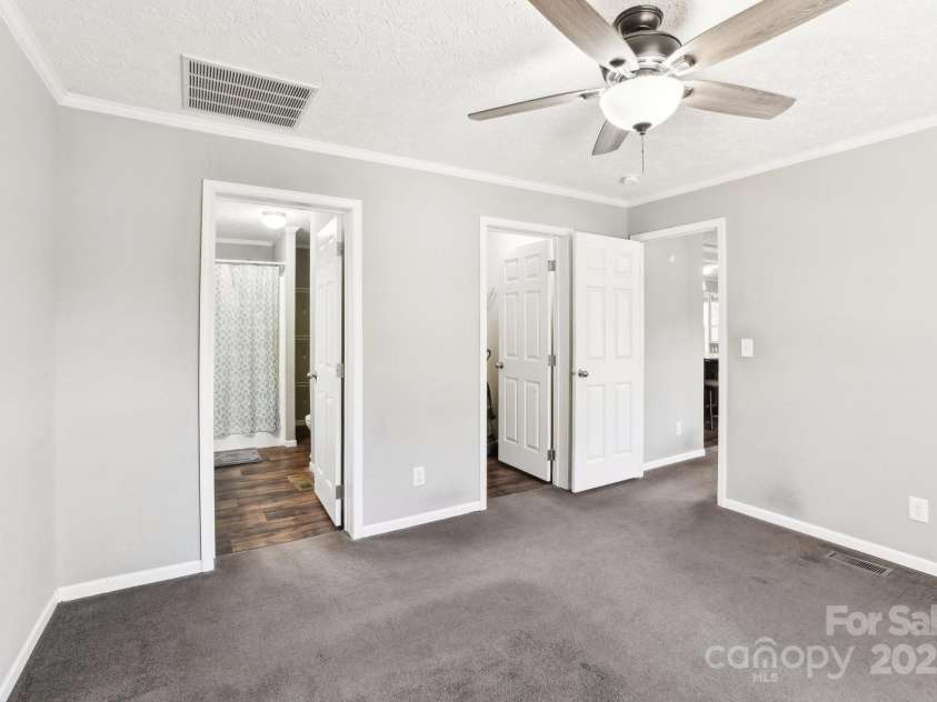 296 Sentelle Lane, Hendersonville, NC 28739.  MLS# CAR4226674, YatesRealty ID 5255. Primary bedroom looking into en suite bathroom and walk in closet