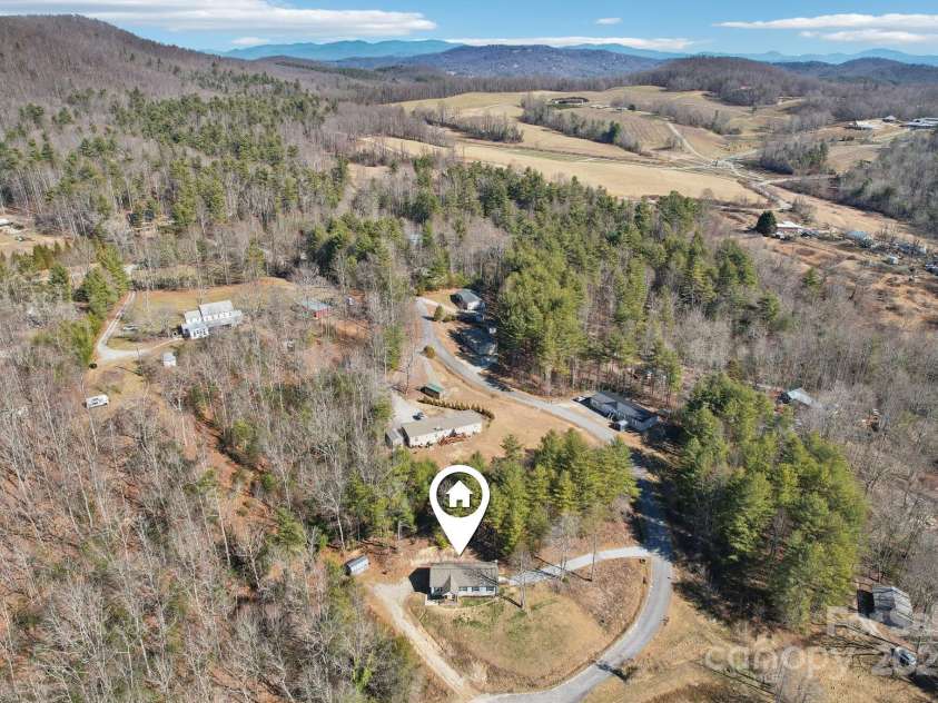 296 Sentelle Lane, Hendersonville, NC 28739.  MLS# CAR4226674, YatesRealty ID 5255. Tucked away on a cul-de-sac in a peaceful neighborhood and just around the corner from Jeter Mountain Farms (see JMF in the distance on this drone photo)