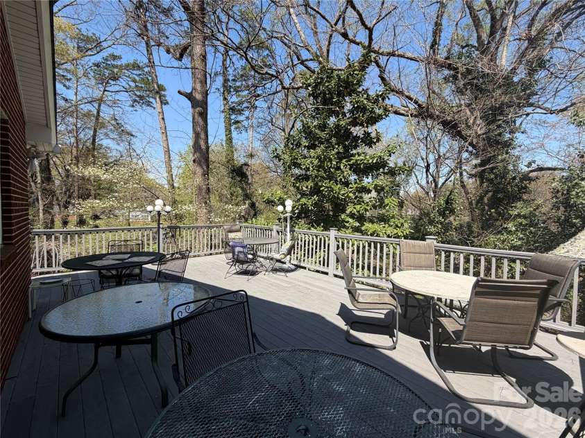 920 Paramount Circle, Gastonia, NC 28052.  MLS# CAR4354209, YatesRealty ID 5257. Oversized composite deck, pictured with 5 round tables. More than enough room for entertaining.