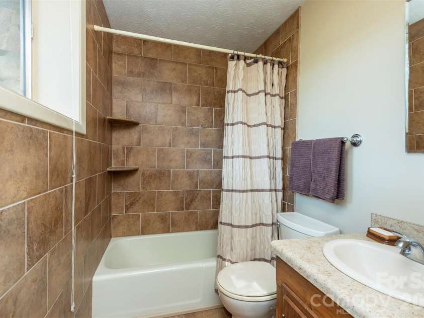 127 College Circle, Swannanoa, NC 28778.  MLS# CAR4427251, YatesRealty ID 52594. Basement full bathroom with tiled shower