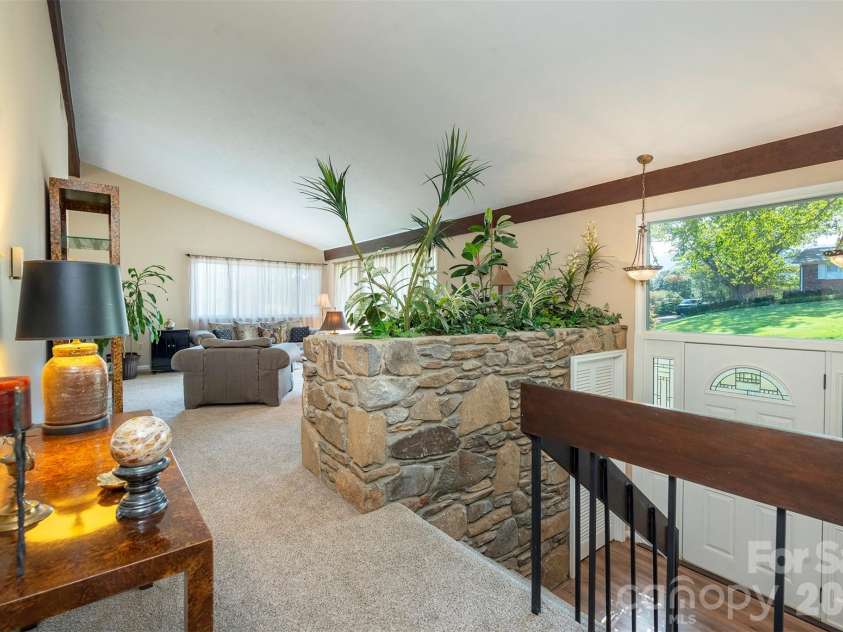 127 College Circle, Swannanoa, NC 28778.  MLS# CAR4427251, YatesRealty ID 52594. Upper-level landing with stone wall accent
