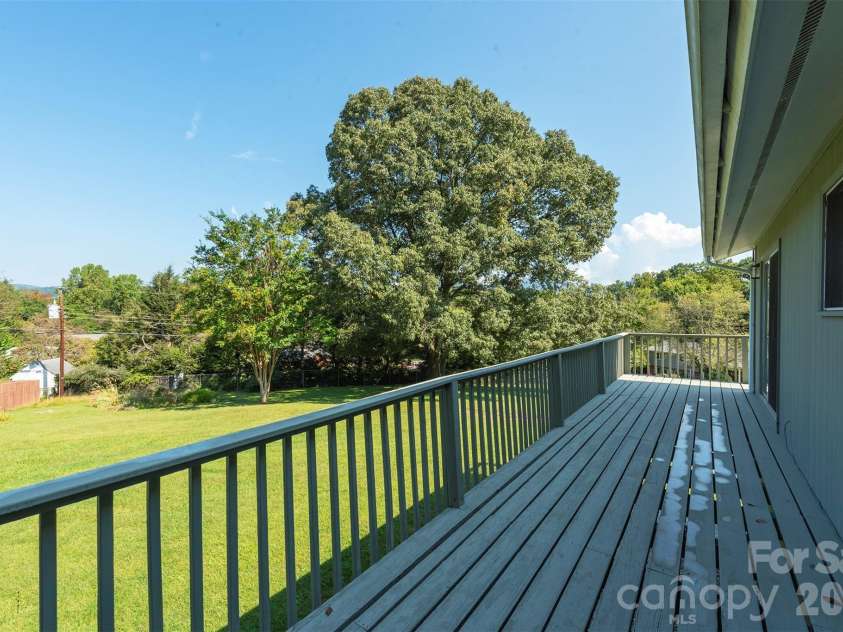 127 College Circle, Swannanoa, NC 28778.  MLS# CAR4427251, YatesRealty ID 52594. Wrap-around deck with mountain views