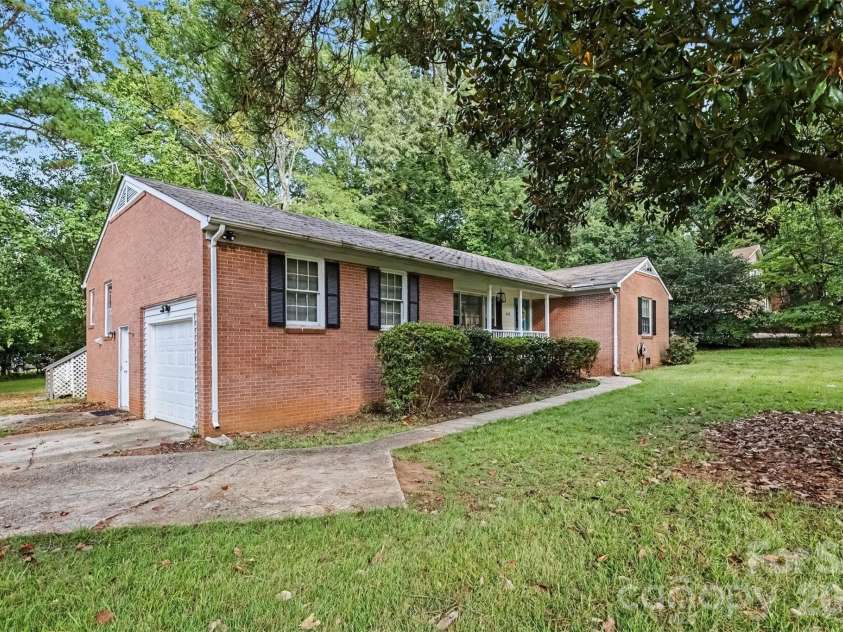 502 Plantation Road, Lancaster, SC 29720.  MLS# CAR4426639, YatesRealty ID 52636. Side view: one-car garage and extra driveway parking