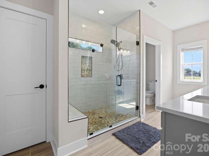 2665 Umberger Road, Cleveland, NC 27013.  MLS# CAR4425571, YatesRealty ID 52643. Large custom shower in primary with linen closet