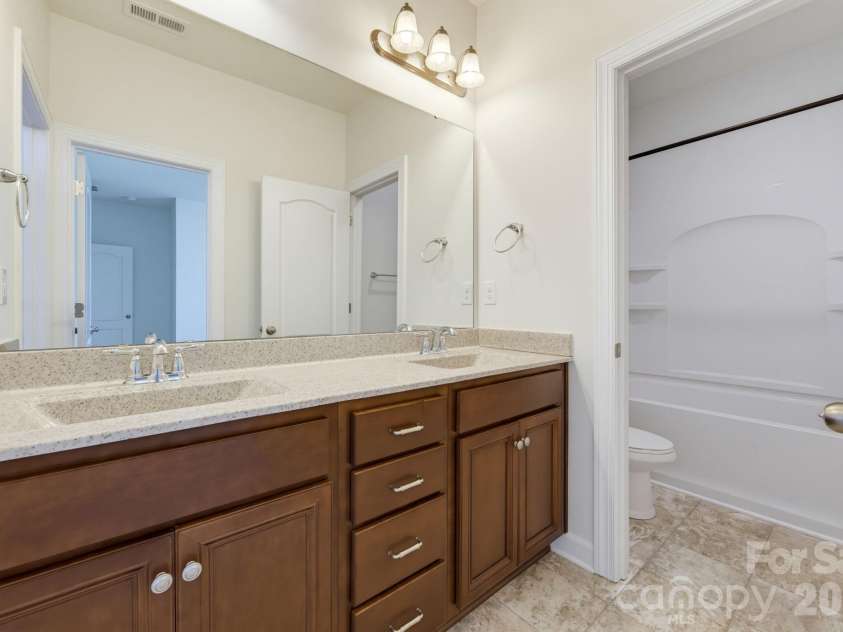 8315 Breton Way, Harrisburg, NC 28075.  MLS# CAR4426522, YatesRealty ID 52653. The shared bath provides a double-sink vanity and convenient access between the secondary bedrooms.