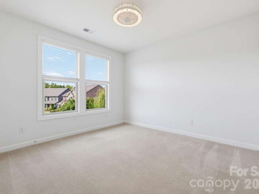 8315 Breton Way, Harrisburg, NC 28075.  MLS# CAR4426522, YatesRealty ID 52653. Two generous windows fill this second-level bedroom with natural light, while its comfortable proportions offer plenty of flexibility for sleeping, studying, and making the space entirely your own.