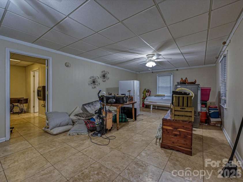 3017 Vernell Lane, Shelby, NC 28150.  MLS# CAR4425376, YatesRealty ID 52670. Spacious finished Basement offering an open, flexible layout with tile flooring, abundant natural light, and endless possibilities for recreation, entertaining, or additional living space.