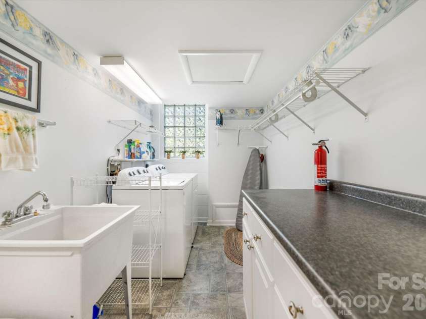 1 Pheasant Ridge Drive, Asheville, NC 28804.  MLS# CAR4424381, YatesRealty ID 52674. Lower level laundry room