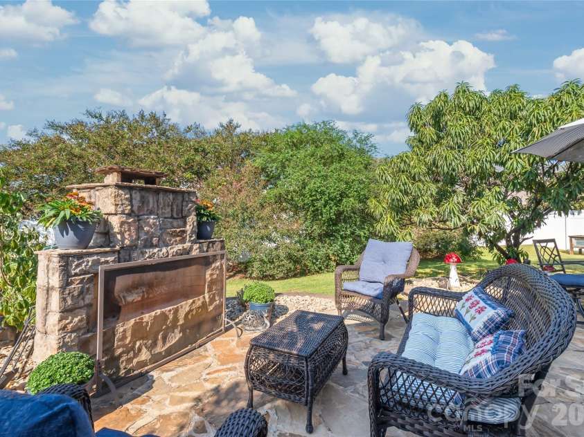 3327 Brackhill Street, Davidson, NC 28036.  MLS# CAR4418504, YatesRealty ID 52682. Backyard living space is so much more than just a patio. Imaging a crisp fall evening around a beutiful fireplace