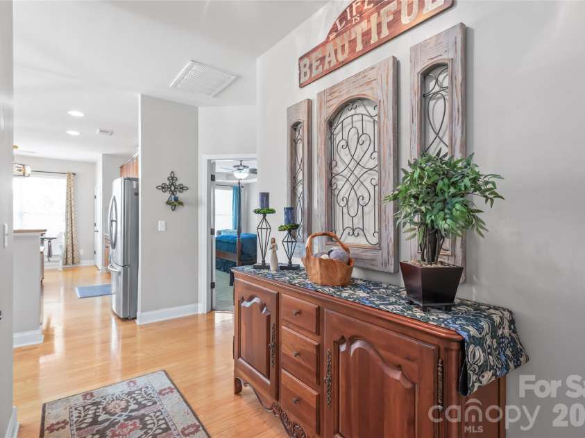 3327 Brackhill Street, Davidson, NC 28036.  MLS# CAR4418504, YatesRealty ID 52682. Breezeway from kitchen to formal dining area with main-level half bath.