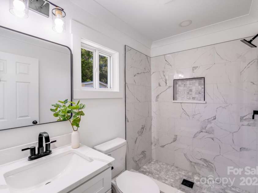 221 River Loop Road, Belmont, NC 28012.  MLS# CAR4245152, YatesRealty ID 5271. Beautiful tiled shower with modern black hardware in the bathroom!