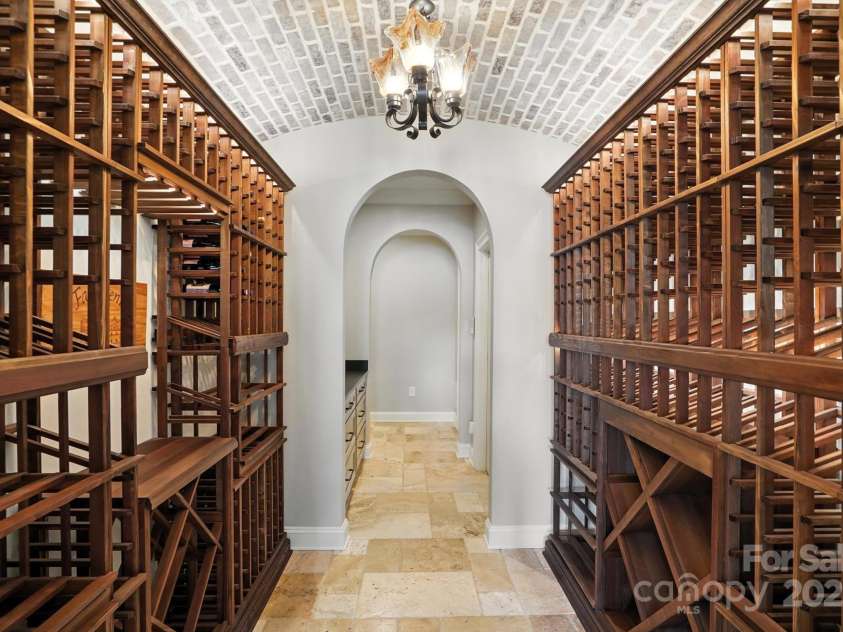 20428 Island Forest Drive, Cornelius, NC 28031.  MLS# CAR4243921, YatesRealty ID 5277. Gorgeous wine cellar with brick ceiling - perfect conversation piece for guests.