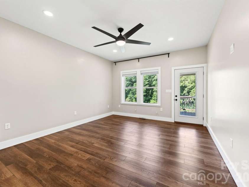 139 Ridge Road, Candler, NC 28715.  MLS# CAR4426704, YatesRealty ID 52790. Primary BR also has access to the covered back deck