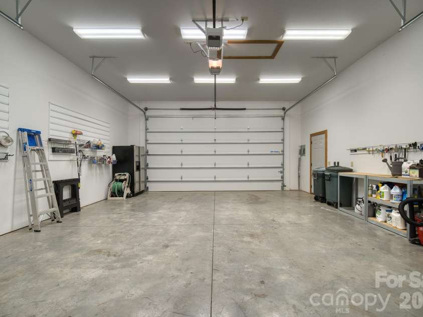 459 West Club Boulevard, Lake Toxaway, NC 28747.  MLS# CAR4220755, YatesRealty ID 5283. Large garage with ample storage and workspace
