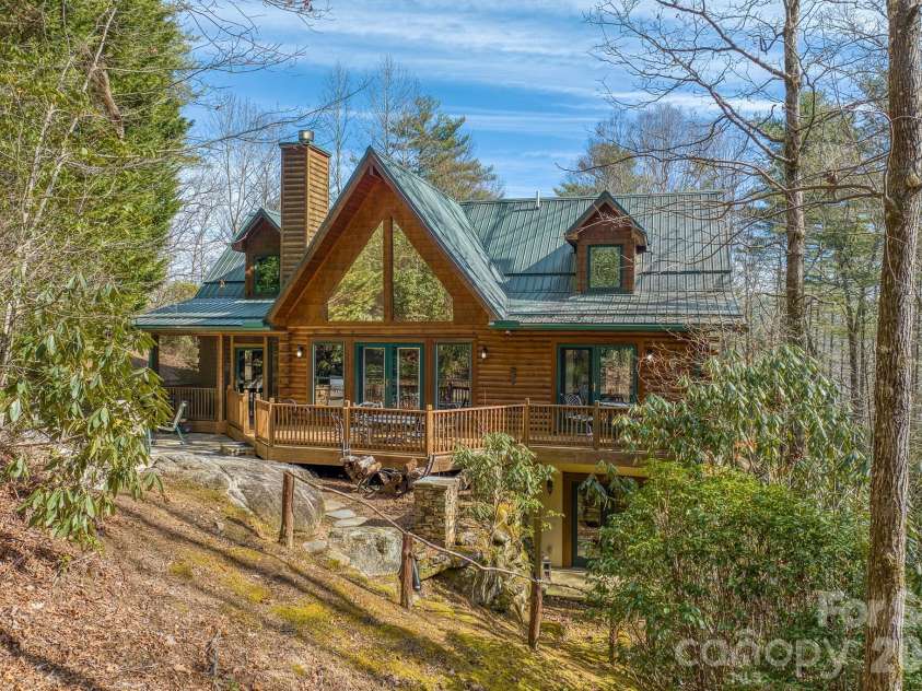 459 West Club Boulevard, Lake Toxaway, NC 28747.  MLS# CAR4220755, YatesRealty ID 5283. Rear elevation with expansive deck and dramatic A-frame window