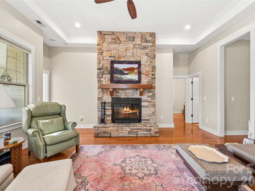 27 Dreambird Drive, Leicester, NC 28748.  MLS# CAR4424552, YatesRealty ID 52857. Cozy fireplace and tall tray ceilings