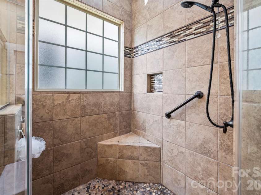 27 Dreambird Drive, Leicester, NC 28748.  MLS# CAR4424552, YatesRealty ID 52857. Primary bath has pebbled zero entry shower