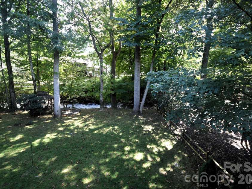 98 Indian Trace Road, Maggie Valley, NC 28751.  MLS# CAR4427039, YatesRealty ID 52864. Creek view from the upper deck