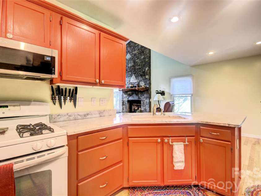 98 Indian Trace Road, Maggie Valley, NC 28751.  MLS# CAR4427039, YatesRealty ID 52864. Kitchen toward the fireplace