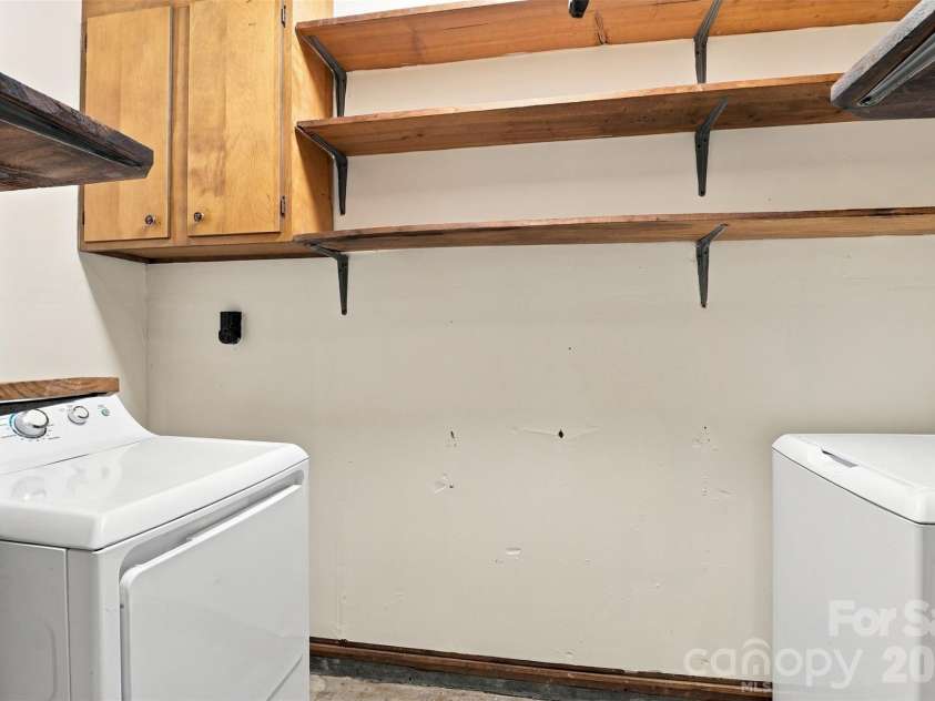 7033 Starvalley Drive, Charlotte, NC 28210.  MLS# CAR4427394, YatesRealty ID 52938. Laundry room with extra cabinets/shelves
