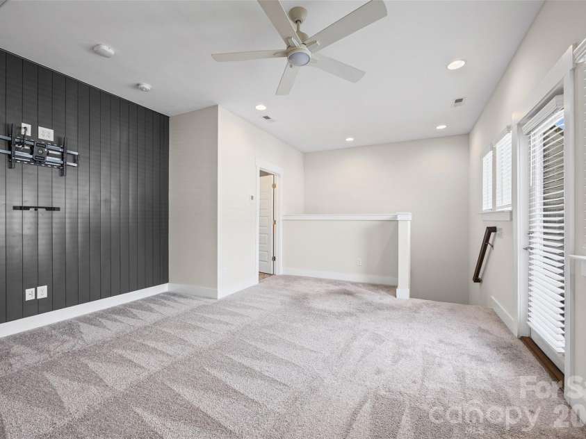 1229 Lomax Avenue, Charlotte, NC 28211.  MLS# CAR4427247, YatesRealty ID 52943. 4th FL: Flex room with a dark paneled accent wall and rooftop access