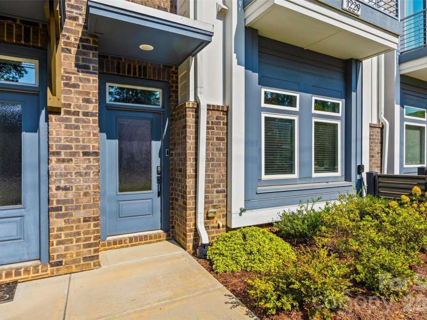 1229 Lomax Avenue, Charlotte, NC 28211.  MLS# CAR4427247, YatesRealty ID 52943. Welcoming front entry with brick and contrasting blue siding