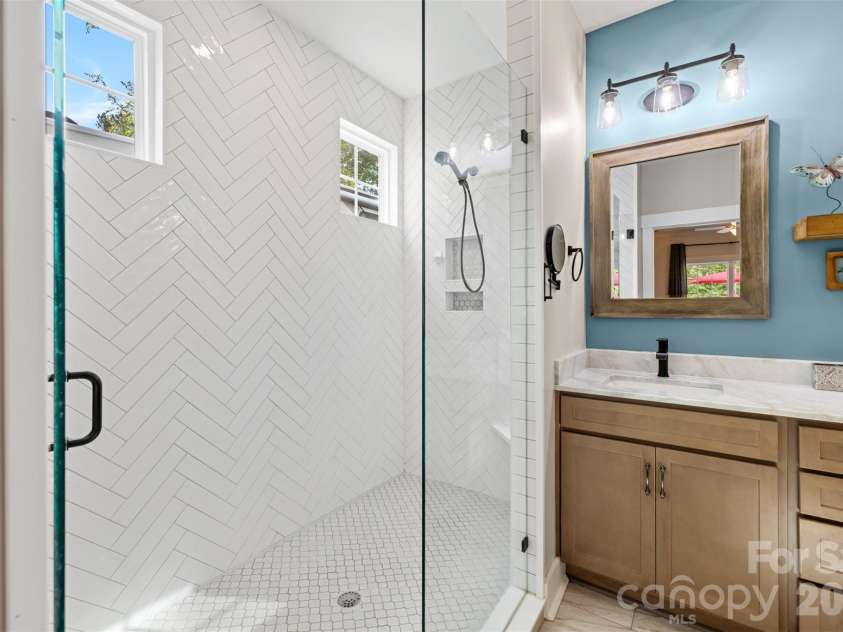 1604 Aragon Beach Road, Rock Hill, SC 29732.  MLS# CAR4427159, YatesRealty ID 52944. Beautifully updated bath with a large herringbone-tiled shower