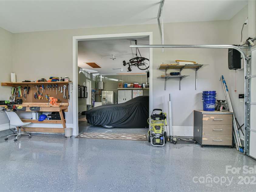 79 Pattys Chapel Road, Fletcher, NC 28732.  MLS# CAR4239671, YatesRealty ID 5295. Garage view from third bay, also has small workbench.
