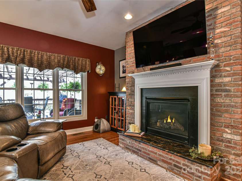 79 Pattys Chapel Road, Fletcher, NC 28732.  MLS# CAR4239671, YatesRealty ID 5295. Gas fireplace with brick facade.