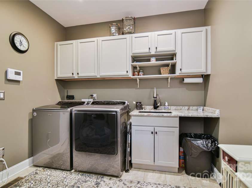 79 Pattys Chapel Road, Fletcher, NC 28732.  MLS# CAR4239671, YatesRealty ID 5295. Laundry features cabinets, granite and a deep sink.