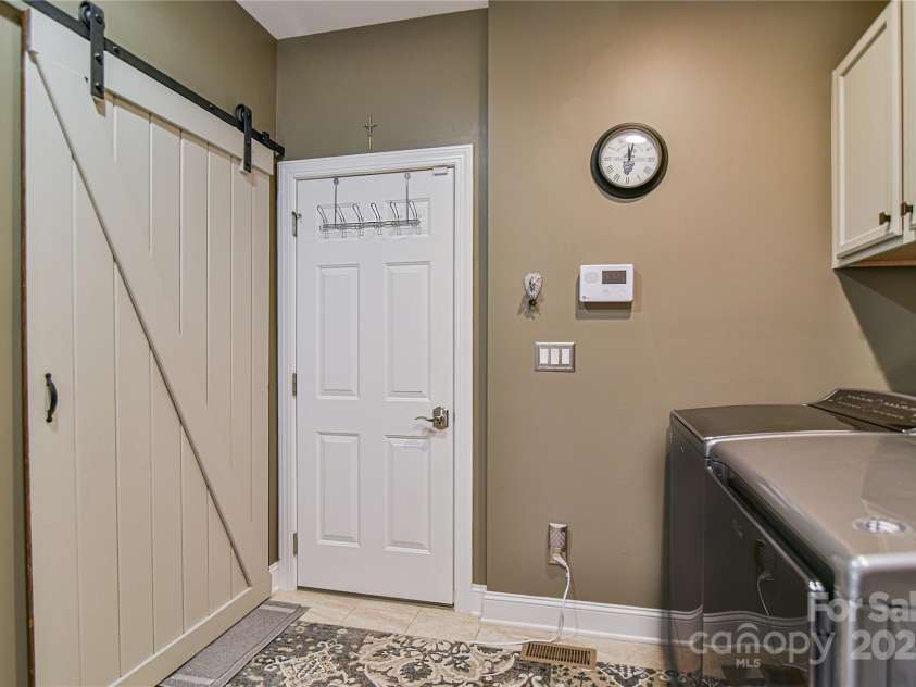 79 Pattys Chapel Road, Fletcher, NC 28732.  MLS# CAR4239671, YatesRealty ID 5295. Laundry leads to garage, closet with sliding door.
