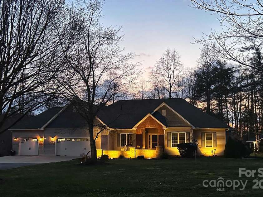 79 Pattys Chapel Road, Fletcher, NC 28732.  MLS# CAR4239671, YatesRealty ID 5295. Property is accented by low-level lighting in the evening.