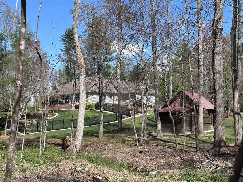 79 Pattys Chapel Road, Fletcher, NC 28732.  MLS# CAR4239671, YatesRealty ID 5295. Rear of the property as seen from across the stream.