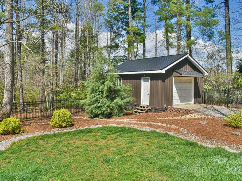 79 Pattys Chapel Road, Fletcher, NC 28732.  MLS# CAR4239671, YatesRealty ID 5295. Workshop shed located inside the back yard fence.