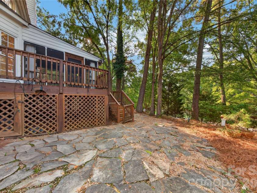 7128 Broadford Court, Charlotte, NC 28277.  MLS# CAR4426890, YatesRealty ID 52952. Stone patio blends with natural setting