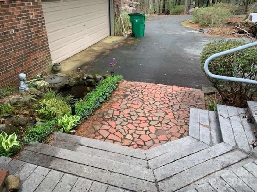 101 LAKEMONT Drive, Flat Rock, NC 28731.  MLS# CAR4246456, YatesRealty ID 53. Entry patio, pond, etc.