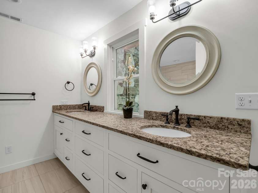 145 Stone Hedge Lane, Tryon, NC 28782.  MLS# CAR4428268, YatesRealty ID 53072. Double vanity with sold surface top