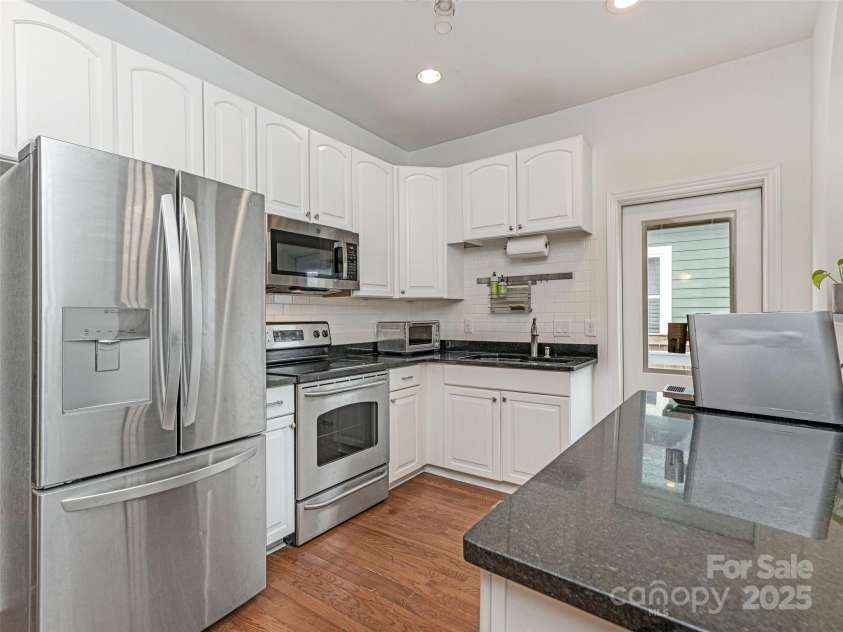 1921 Union Street, Charlotte, NC 28205.  MLS# CAR4222897, YatesRealty ID 5320. Kitchen with granite countertops and white cabinets