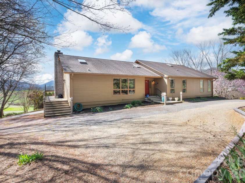 25 New Morning Place, Leicester, NC 28748.  MLS# CAR4356368, YatesRealty ID 5326. Ample parking area with wraparound deck