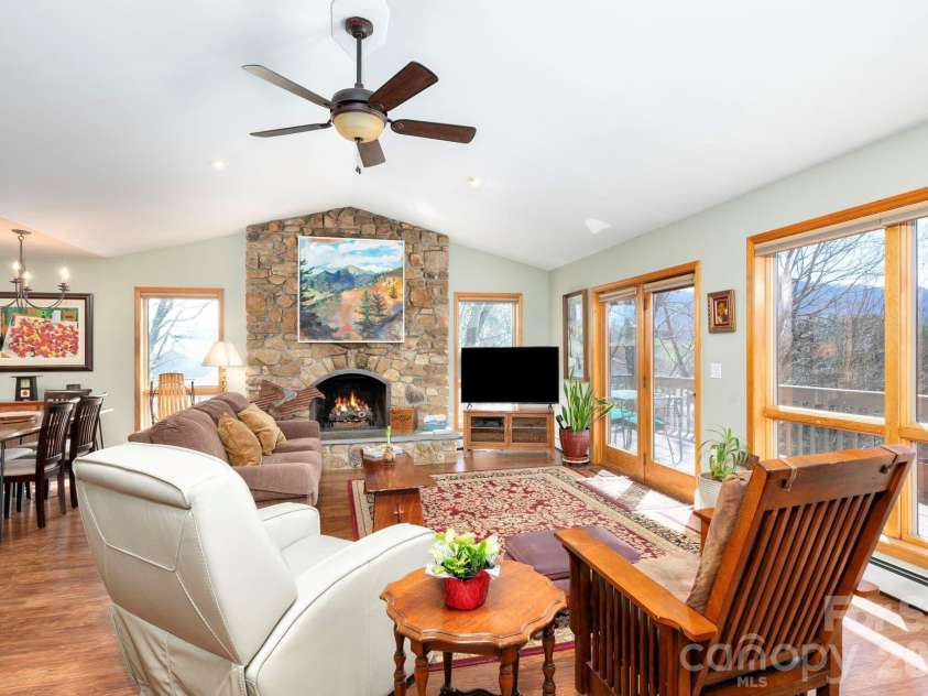 25 New Morning Place, Leicester, NC 28748.  MLS# CAR4356368, YatesRealty ID 5326. Stone fireplace with vaulted ceiling