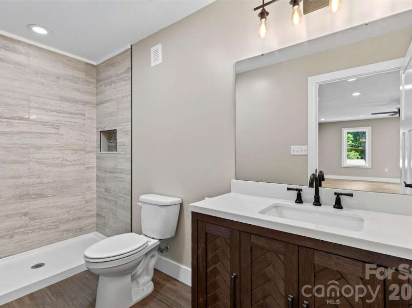 131 Ridge Road, Candler, NC 28715.  MLS# CAR4427732, YatesRealty ID 53263. Downstairs guest bathroom