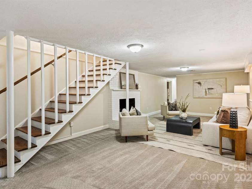 500 Lansdowne Road, Charlotte, NC 28270.  MLS# CAR4240388, YatesRealty ID 5327. Downstairs, you'll find a second large living area with a cozy woodburning fireplace.