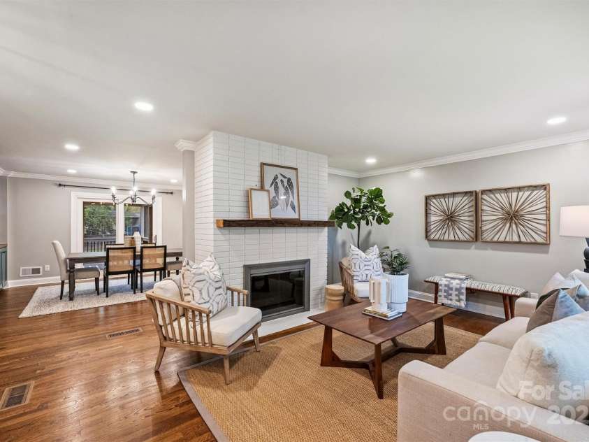500 Lansdowne Road, Charlotte, NC 28270.  MLS# CAR4240388, YatesRealty ID 5327. Welcoming living area with a cozy woodburning fireplace and abundant natural light.