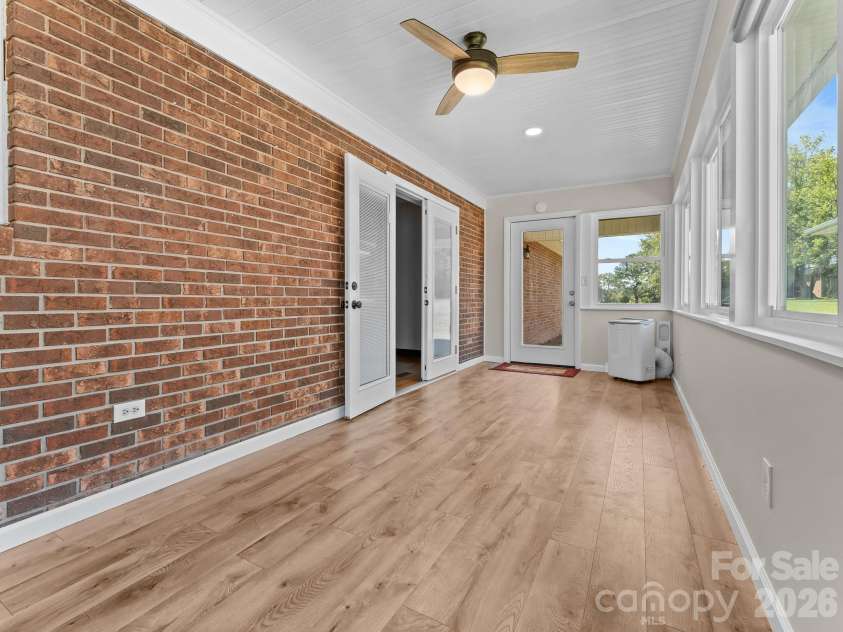 106 Mohican Trail, East Flat Rock, NC 28726.  MLS# CAR4427684, YatesRealty ID 53292. Sunroom overlooking back yard