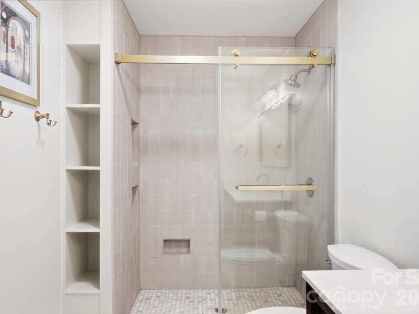 1814 Summerhill Drive, Charlotte, NC 28212.  MLS# CAR4421156, YatesRealty ID 53325. Fully tiled shower with built in storage nooks