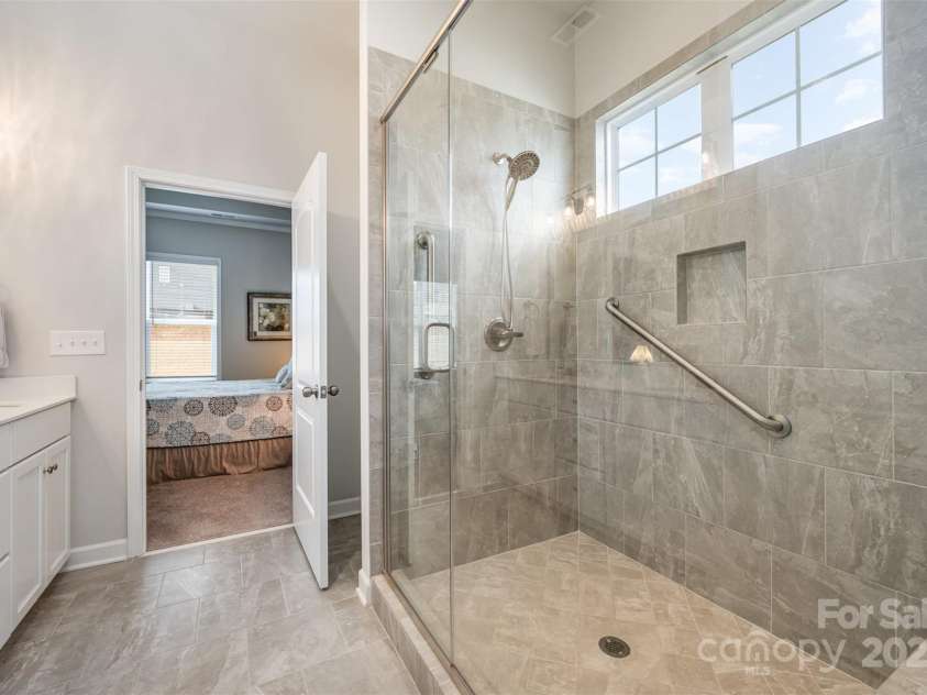 456 Lucky Drive, Concord, NC 28027.  MLS# CAR4235721, YatesRealty ID 5338. Large, step in tile shower with grab bar