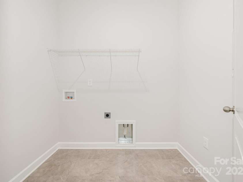 456 Lucky Drive, Concord, NC 28027.  MLS# CAR4313263, YatesRealty ID 5338. Laundry room right off the 3-car garage entry.