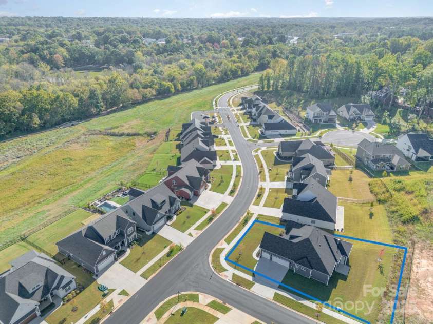 456 Lucky Drive, Concord, NC 28027.  MLS# CAR4313263, YatesRealty ID 5338. Street scape of this lovely Concord neighborhood with the walking trail just a few houses down from this lovely corner home site. Lot lines are approximate.