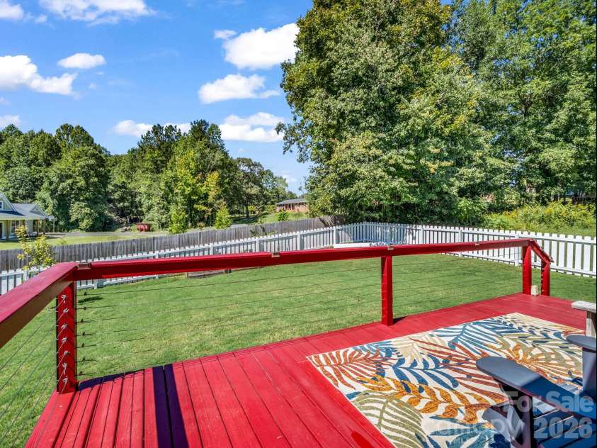 178 Page Creek Boulevard, Landrum, SC 29356.  MLS# CAR4428933, YatesRealty ID 53387. Deck overlooks the fenced back yard